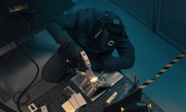 Welder sitting at a safe welding table covered in PPE