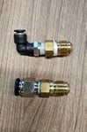 A 6 mm push-to-connect elbow fitting next to a straight fitting, both with 1/4 inch NPT threads