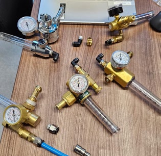 Five gas regulators with flow meters, each fitted with a flare coupling and a push-to-connect fitting for the MA1